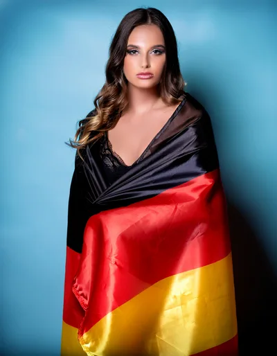 Young Woman Wrapped In A German Flag