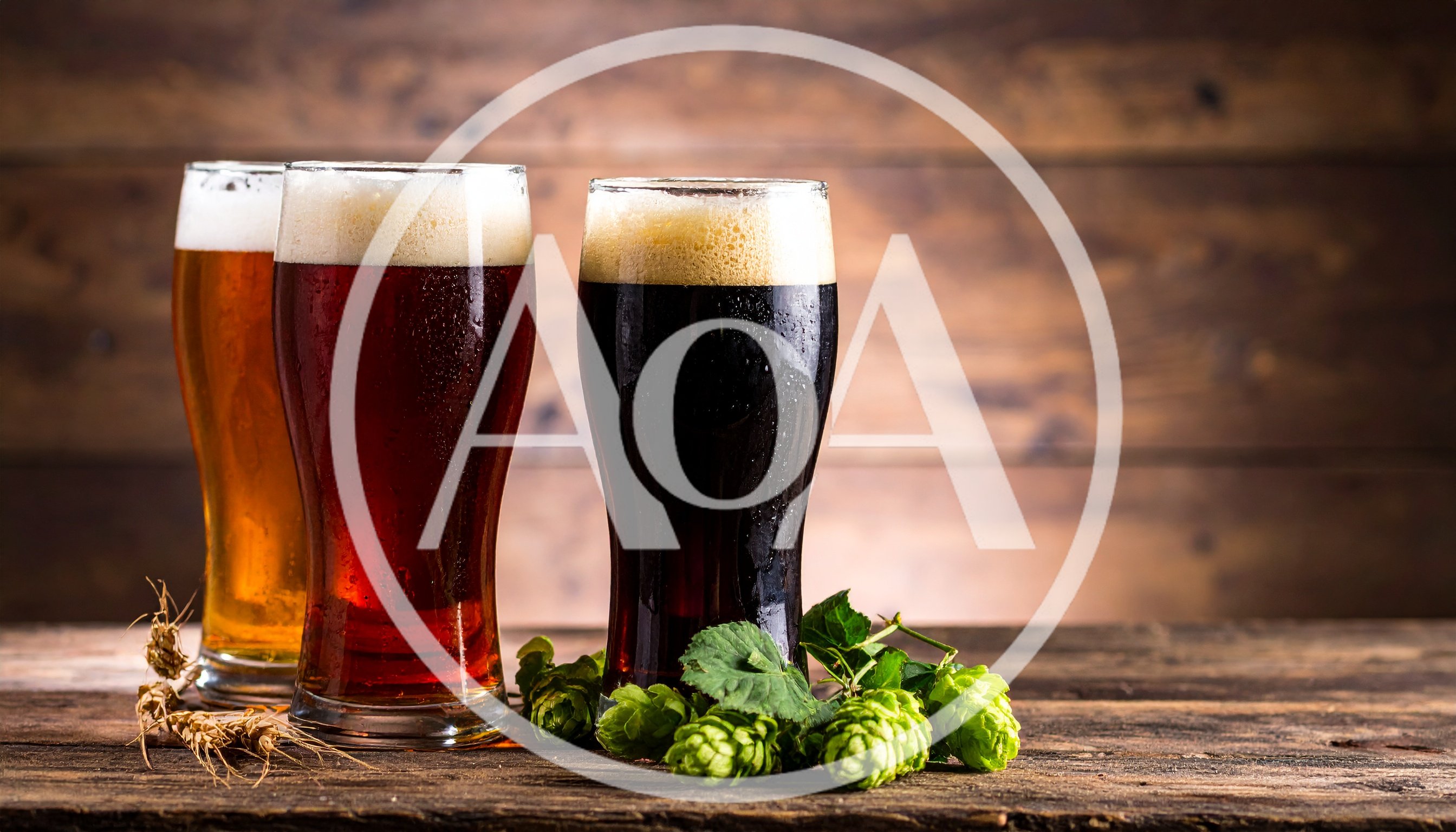 Three Glasses Of Beer With Hops On Wooden Table