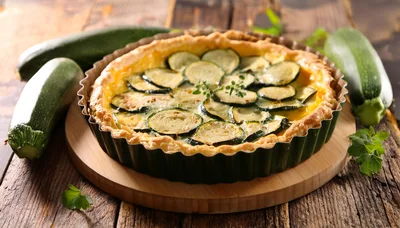Freshly Baked Zucchini Quiche On A Wooden Board