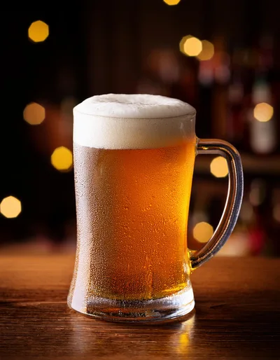 Cold Glass Mug Of Golden Beer On Wooden Bar