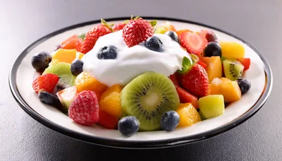 Fresh Fruit Salad Bowl With Cream Topping