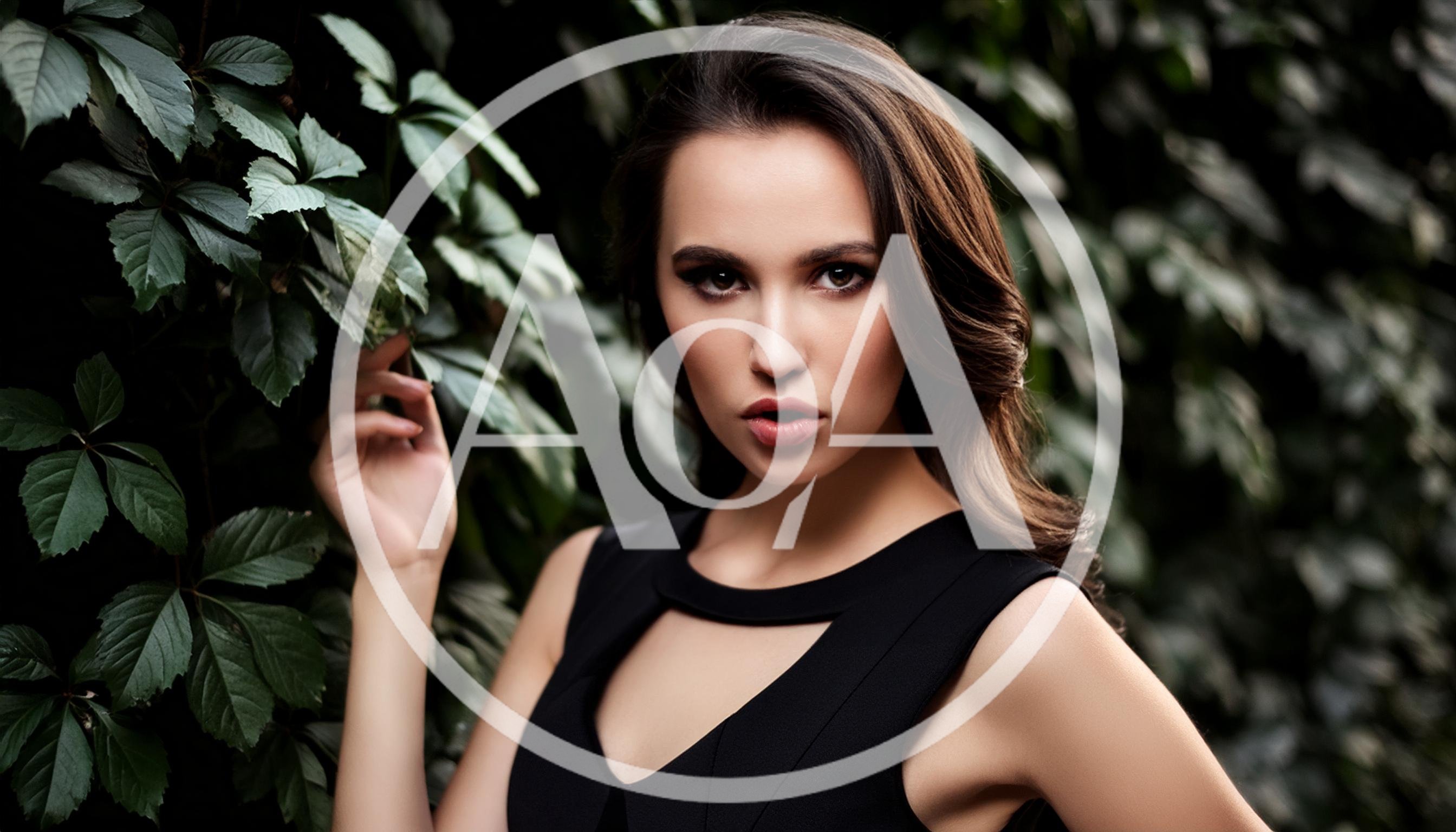 Portrait Of A Beautiful Woman Standing By Ivy Leaves
