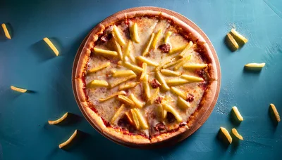 Pizza Topped With French Fries On A Blue Background