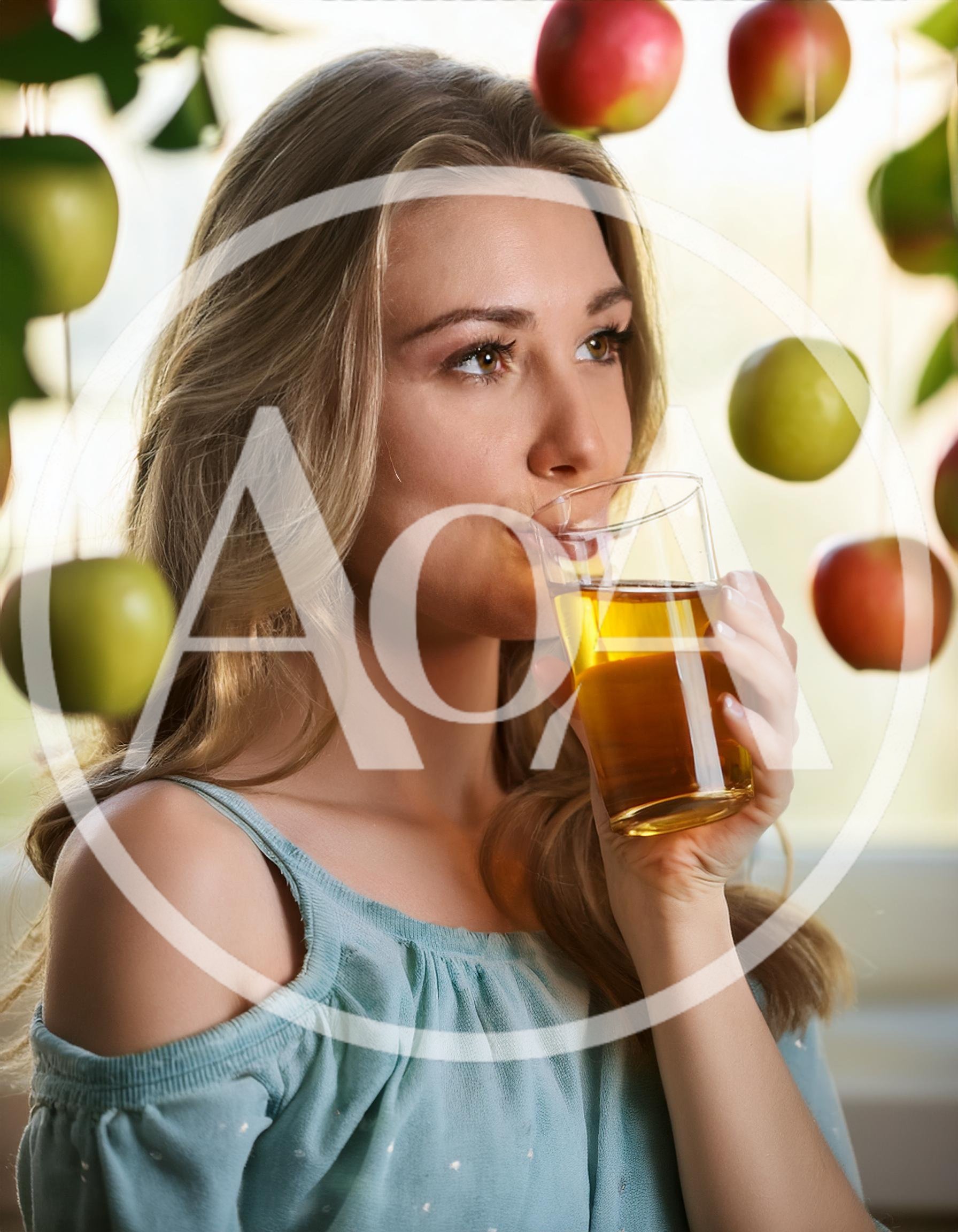 Young Woman Drinking Fresh Apple Juice