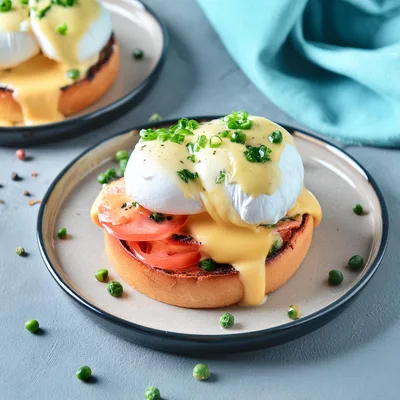 Eggs Benedict With Tomato Slices On A Plate