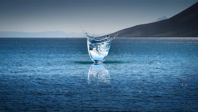 Glass Of Water Splashing On Ocean Surface