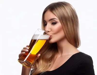 Beautiful Blonde Woman Drinking Beer From A Glass