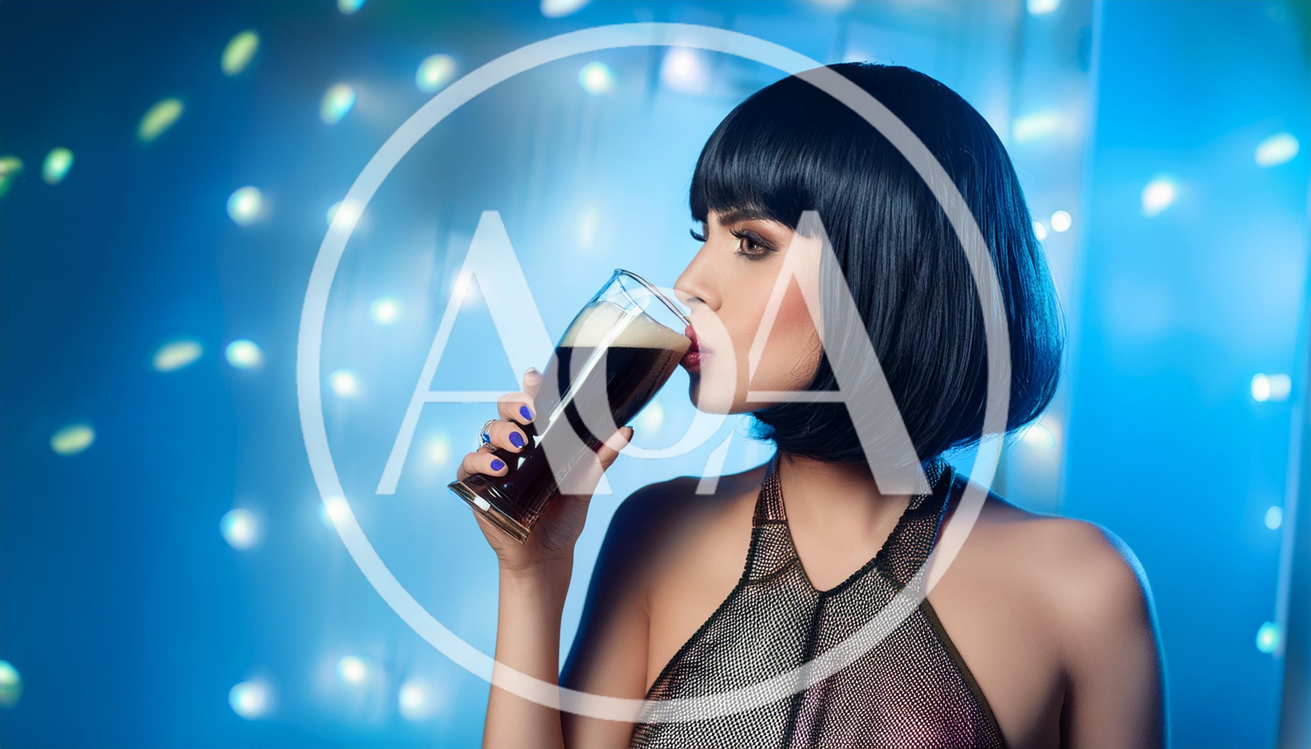 Woman With Bob Haircut Drinking Dark Beer