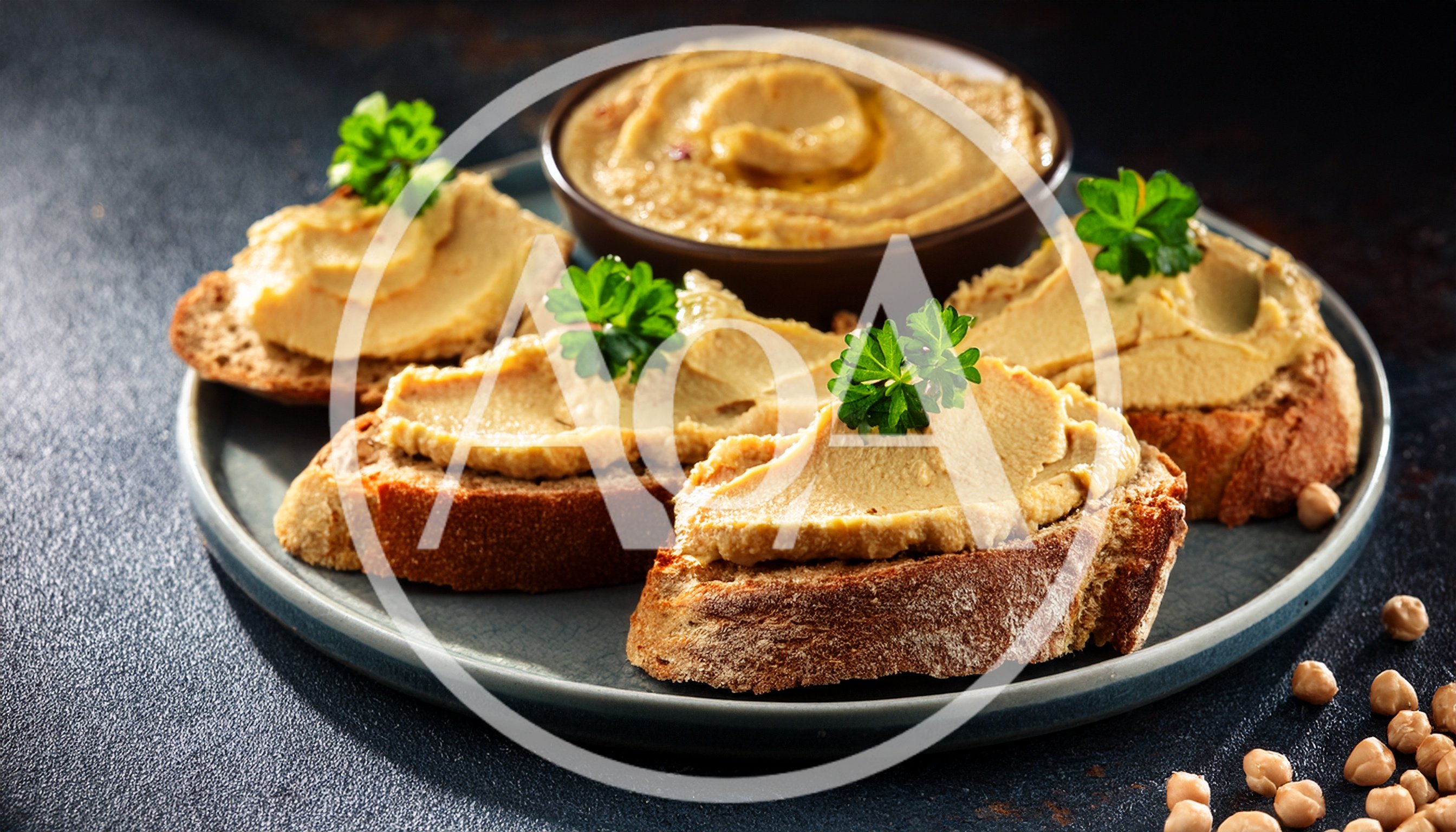 Hummus Topped Toasted Bread Slices on Plate