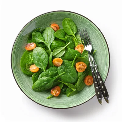 Fresh Spinach Salad With Cherry Tomatoes In Green Bowl
