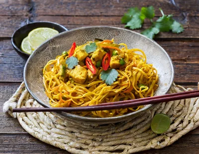 Bowl Of Curry Chicken Noodles With Fresh Chili