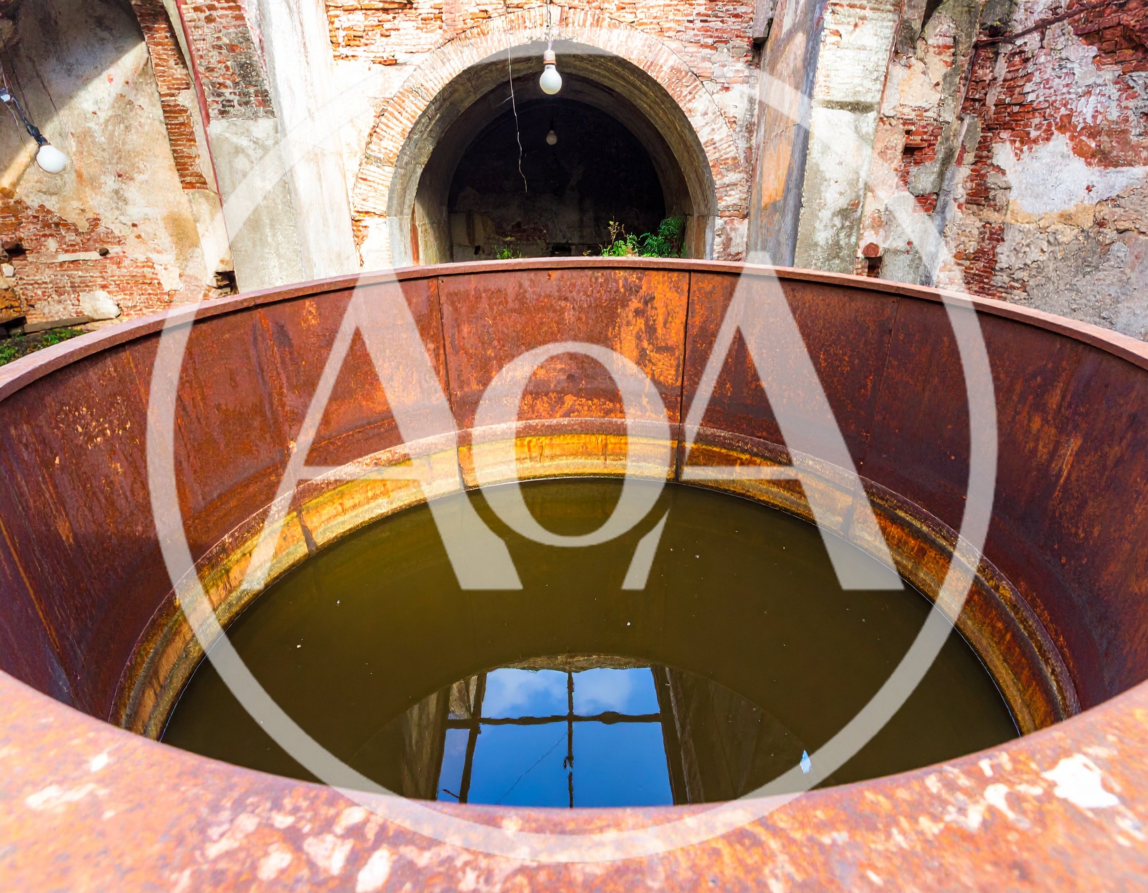 Large Rusty Metal Vat In Abandoned Brick Building