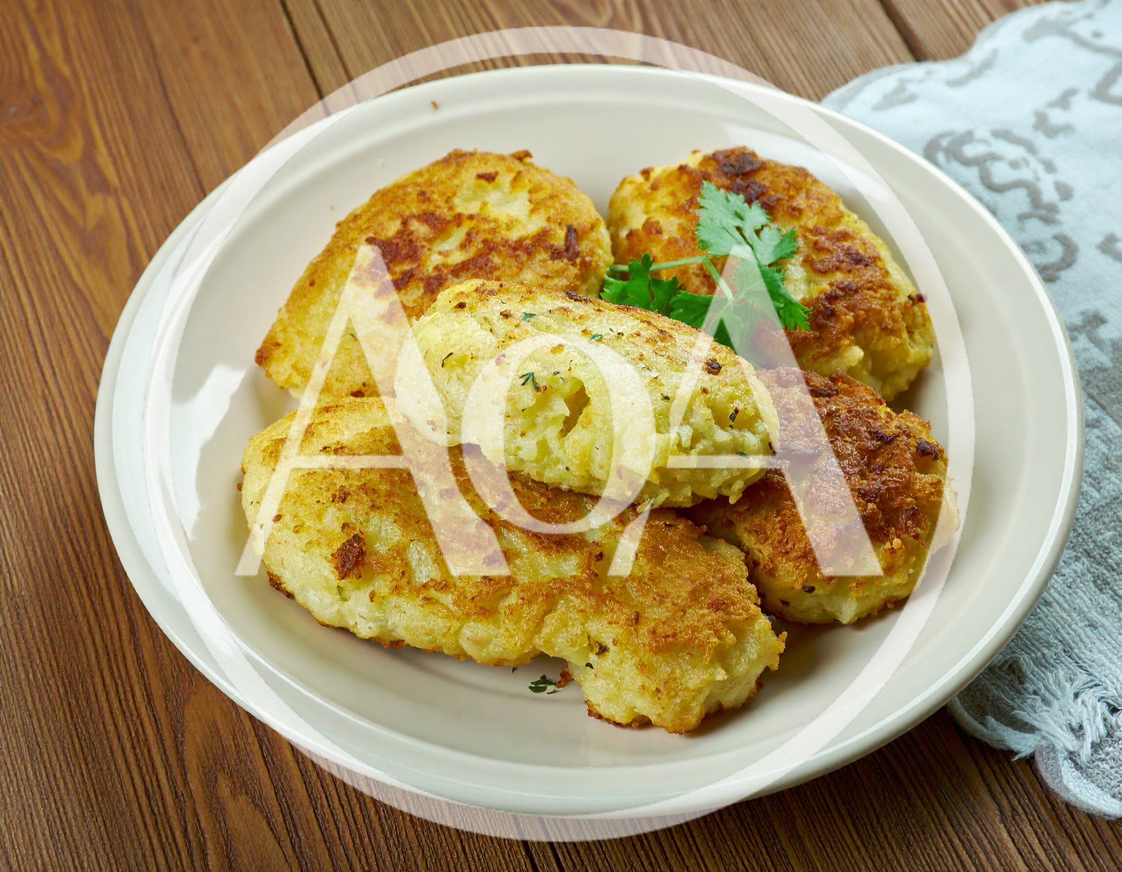 Homemade Potato Patties Served On A White Plate