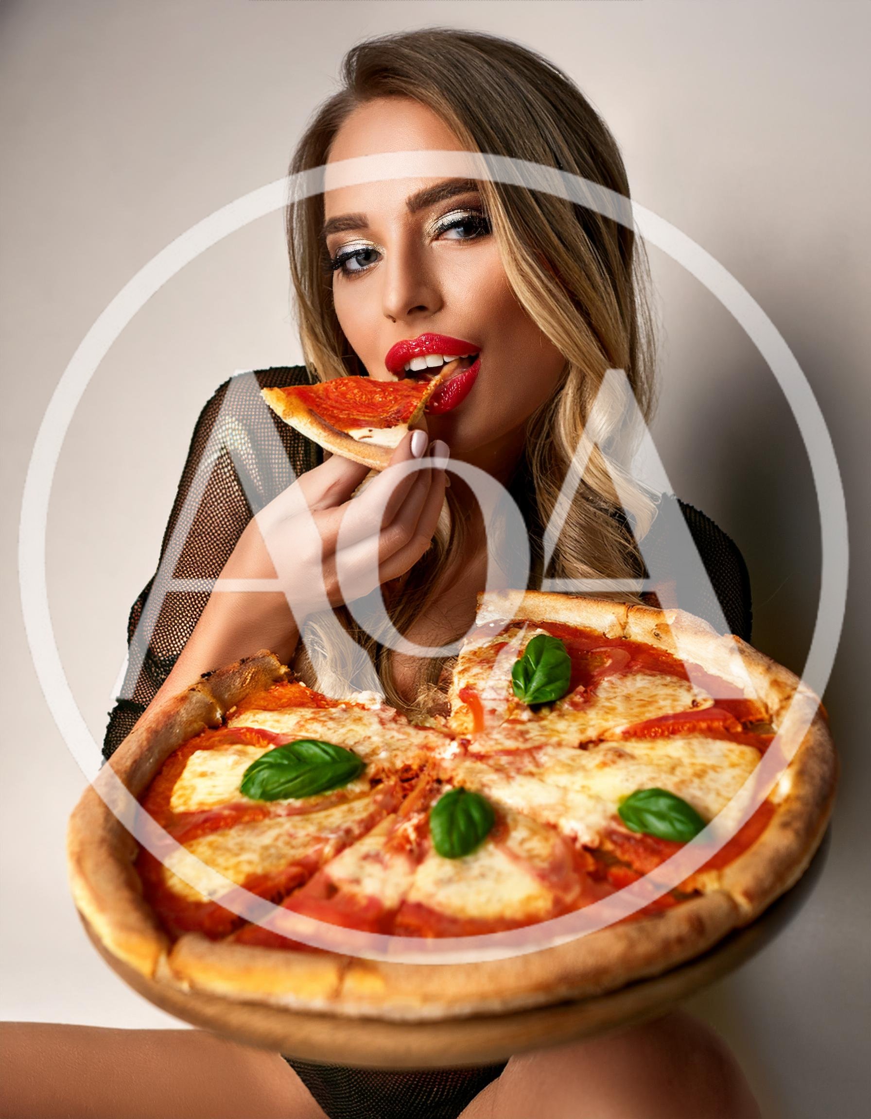 Beautiful Woman Eating A Slice Of Margherita Pizza