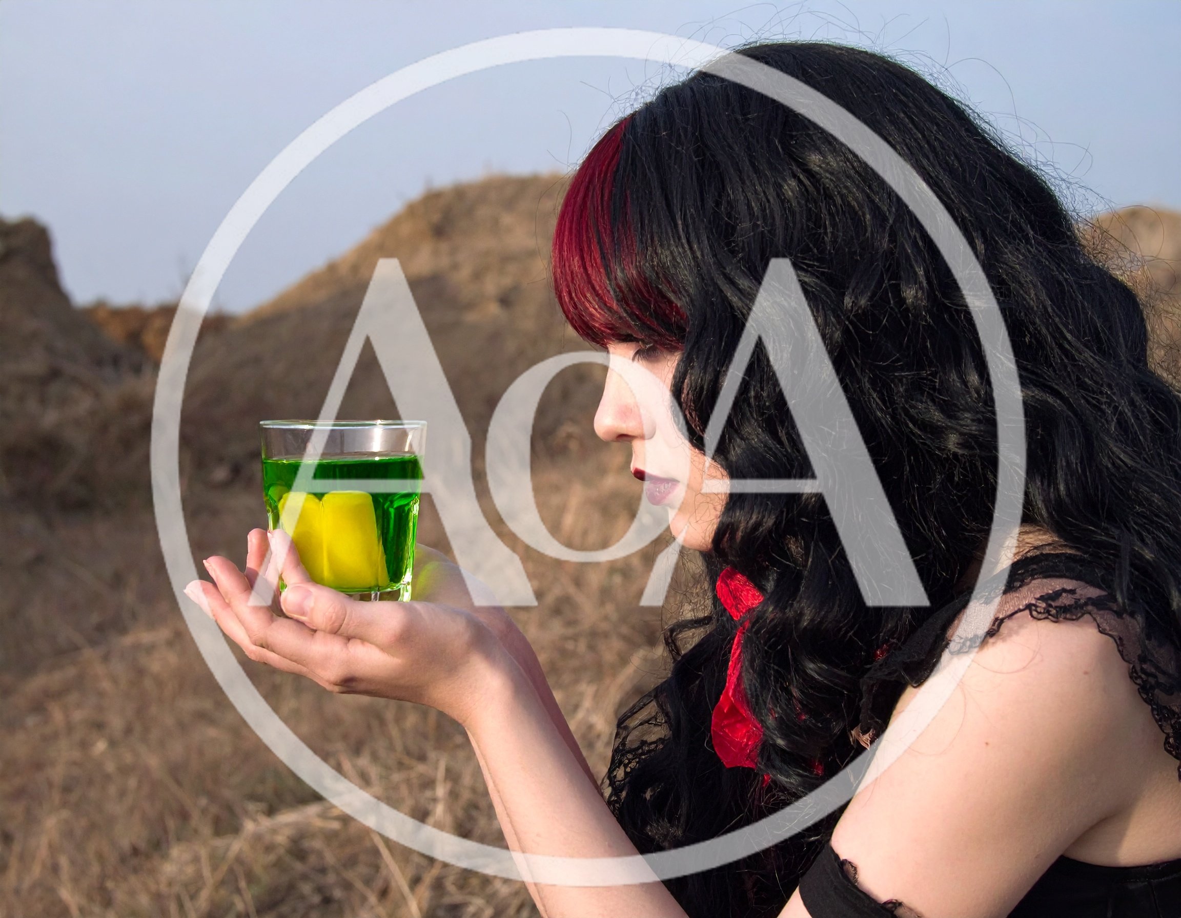 Gothic Woman Holding A Glass Of Green Liquid