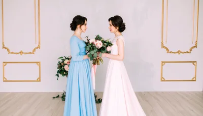 Two Women Holding A Wedding Bouquet In A Studio