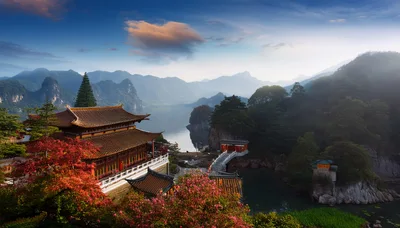 Traditional Chinese Temple Complex Overlooking A Serene Mountain Lake