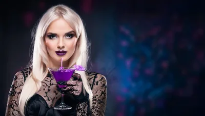 Blonde Woman Holding A Purple Cocktail In Lace Gloves