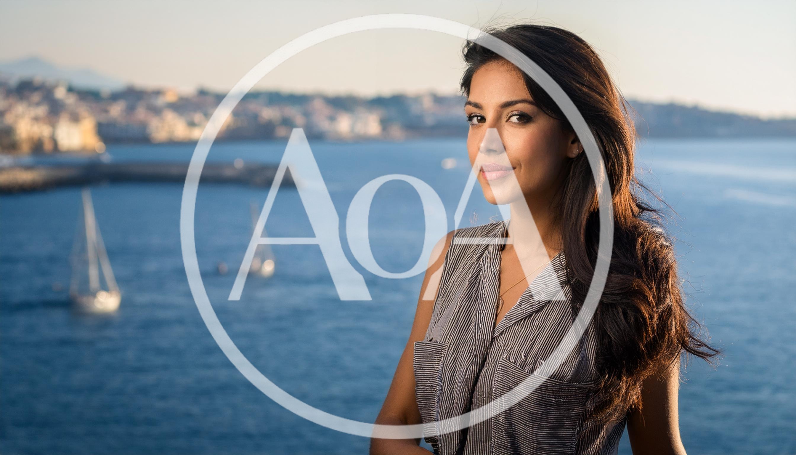 Young Woman Posing Against A Scenic Coastal Background