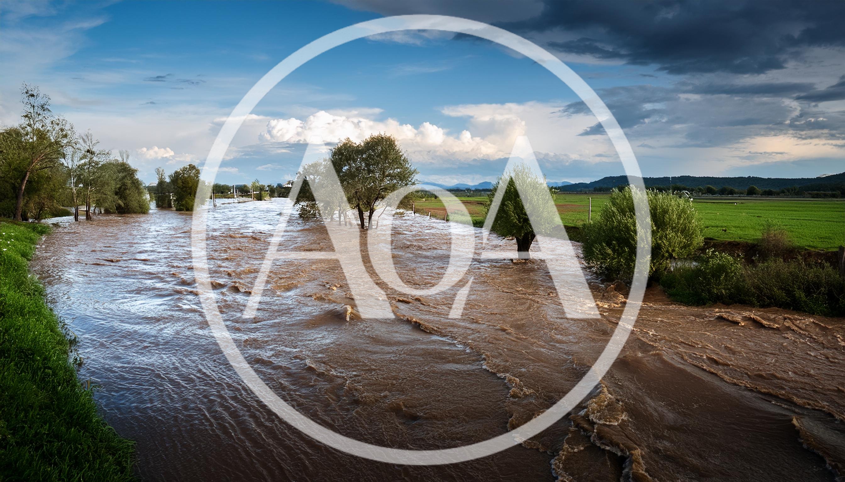 Flooded River Overflowing Into Green Agricultural Fields