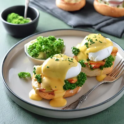 Two Eggs Benedict With Hollandaise Sauce And Parsley