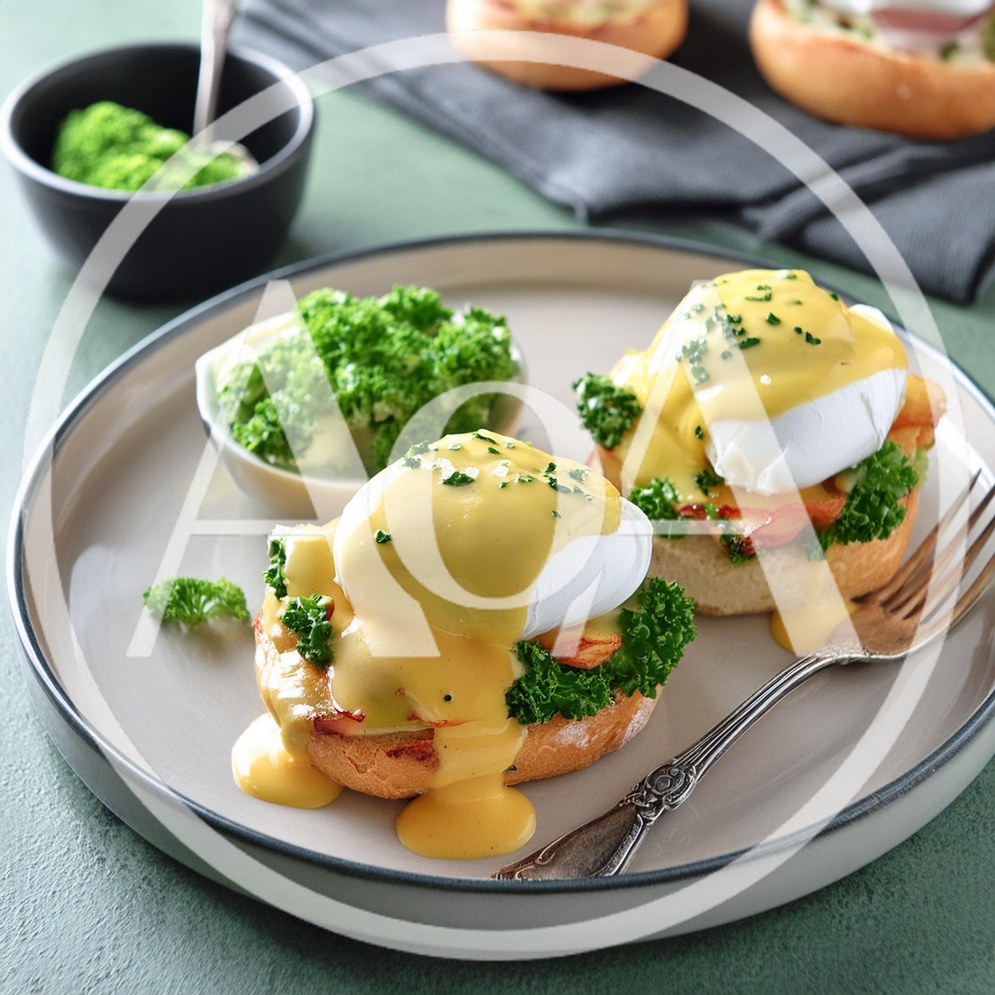 Two Eggs Benedict With Hollandaise Sauce And Parsley