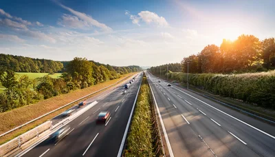 Cars Driving on a Highway at Sunset