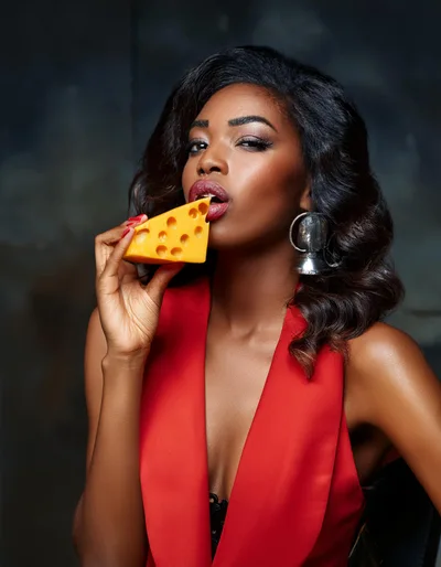 Elegant Woman Holding A Piece Of Swiss Cheese