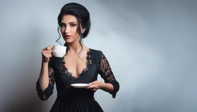 Elegant Woman Holding A Tea Cup And Saucer