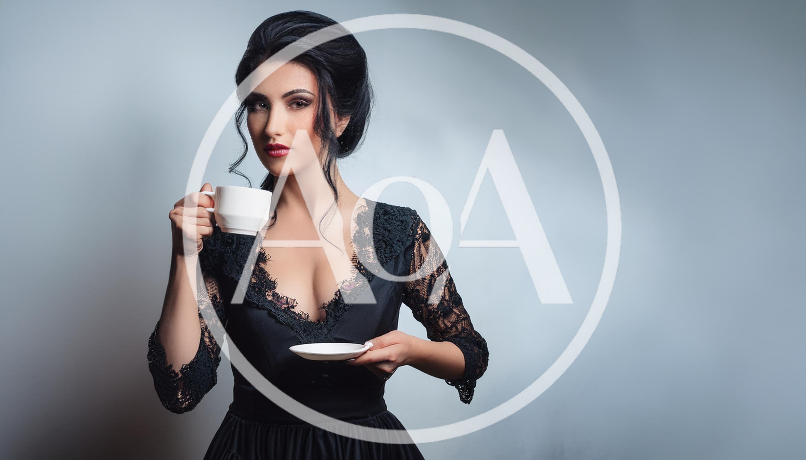 Elegant Woman Holding A Tea Cup And Saucer