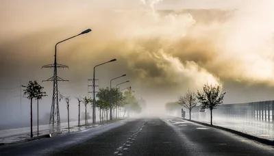 Empty Asphalt Road Under Dramatic Foggy Sky