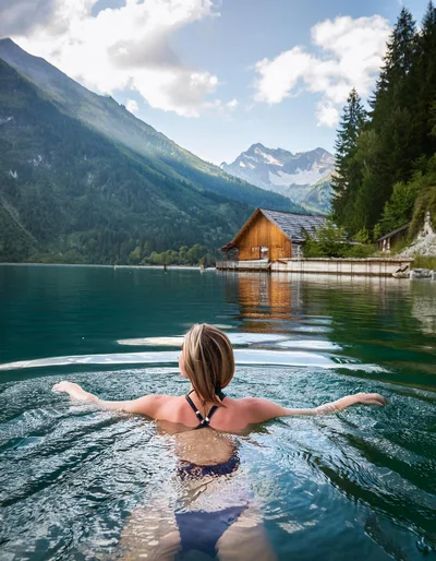 Woman Swimming In A Scenic Alpine Lake