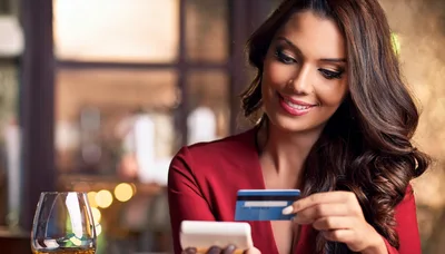 Woman Paying With Credit Card At Restaurant