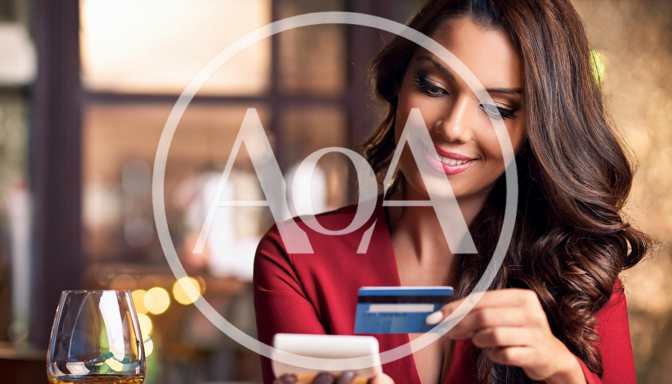 Woman Paying With Credit Card At Restaurant