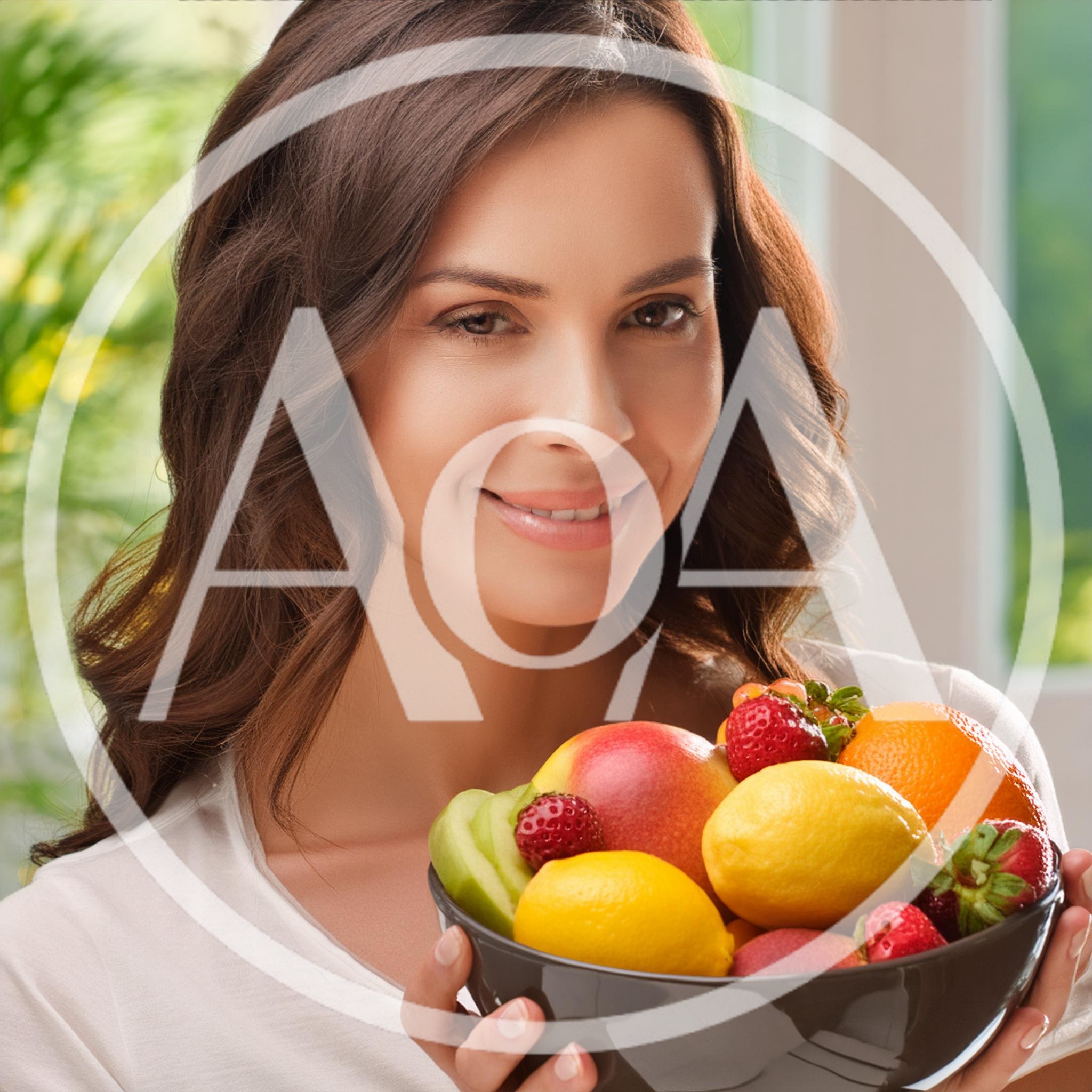 Smiling Woman Holding A Bowl Of Fresh Fruit