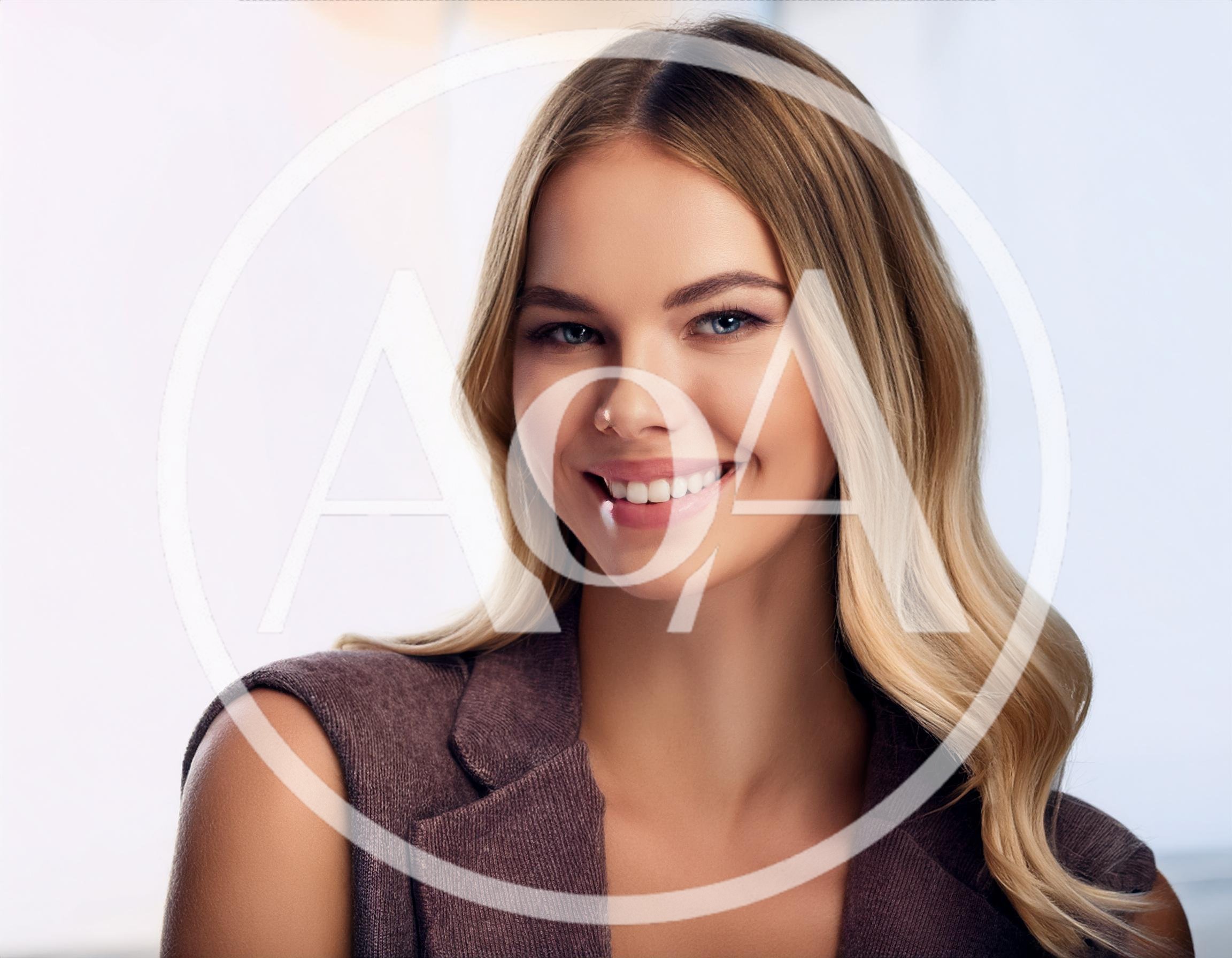 Portrait Of A Smiling Blonde Woman In Professional Attire