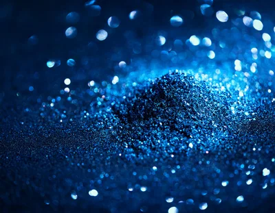 Blue Glitter Pile With Bokeh Background