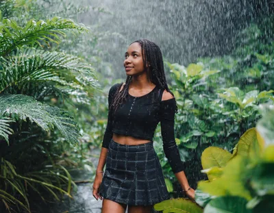 Young Woman Standing In Tropical Rain