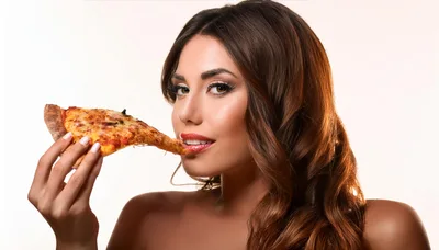 Beautiful Woman Eating A Slice Of Pizza