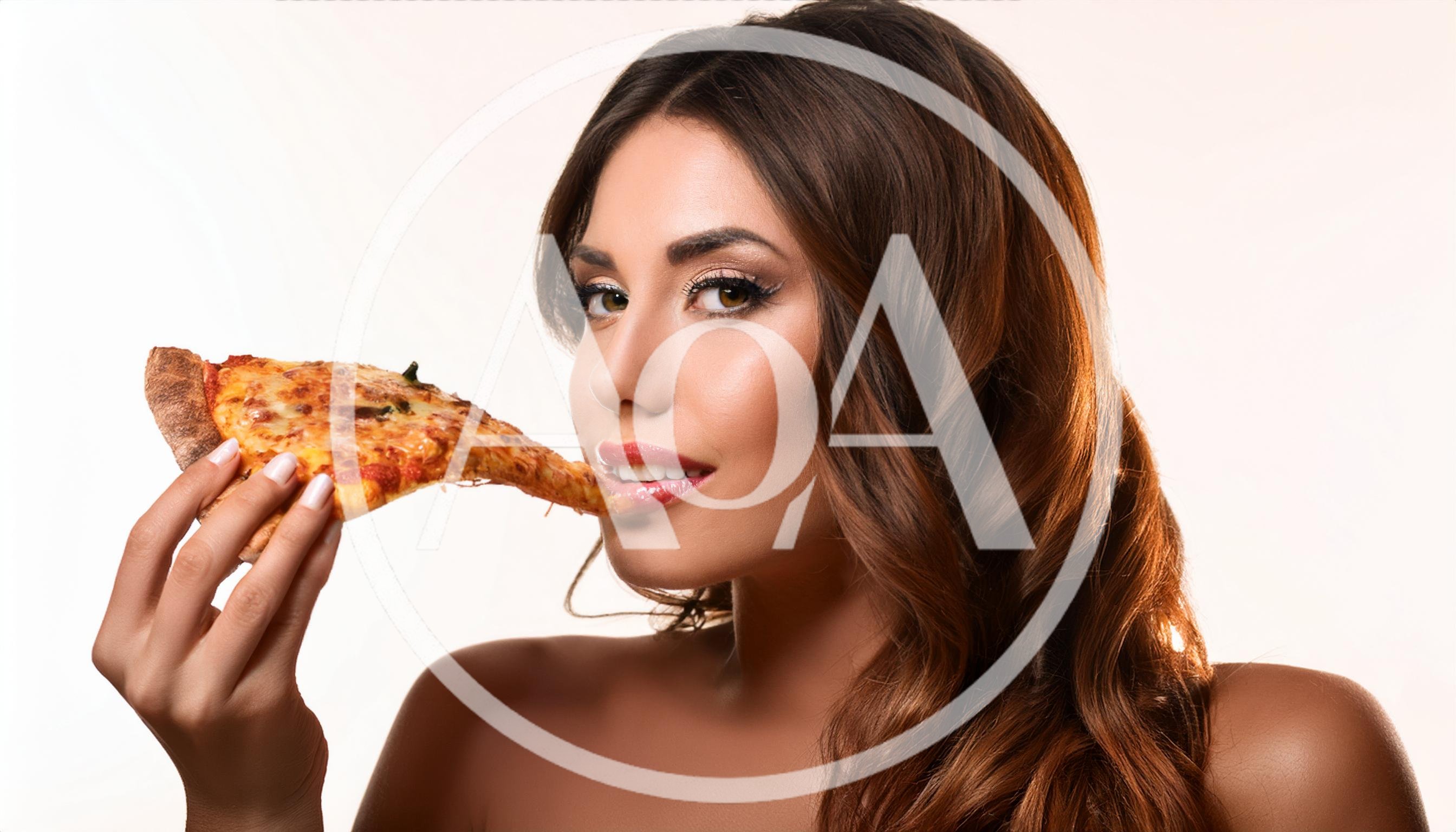 Beautiful Woman Eating A Slice Of Pizza