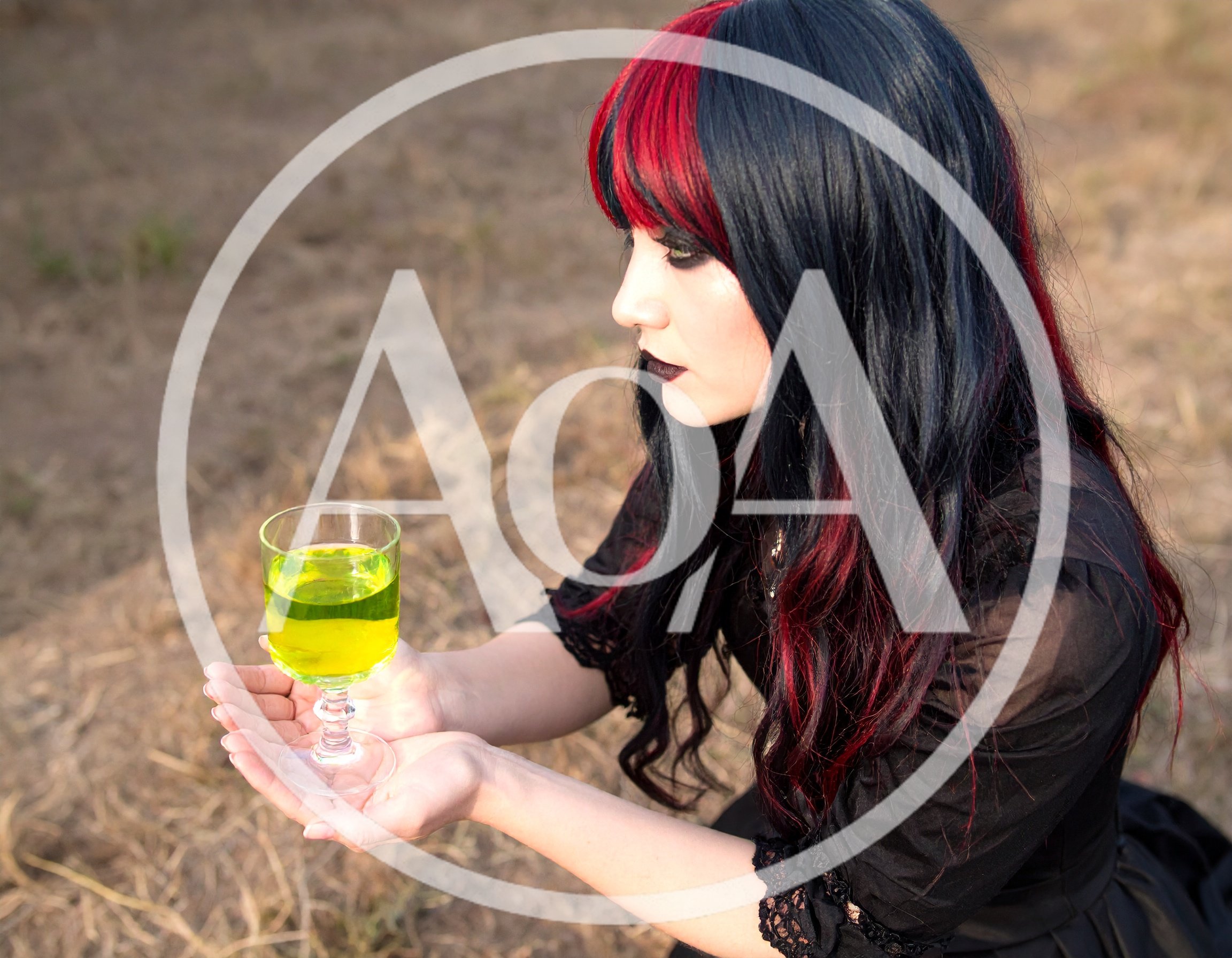 Goth Woman Holding A Glass Of Glowing Green Potion