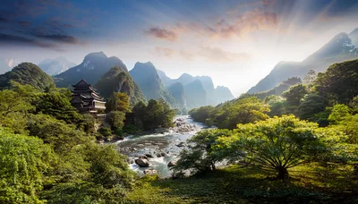 Traditional Pagoda Beside A Mountain River At Sunrise