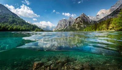 Split Level View Of Alpine Lake And Mountains