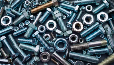 Assorted Metal Bolts and Nuts on Dark Background