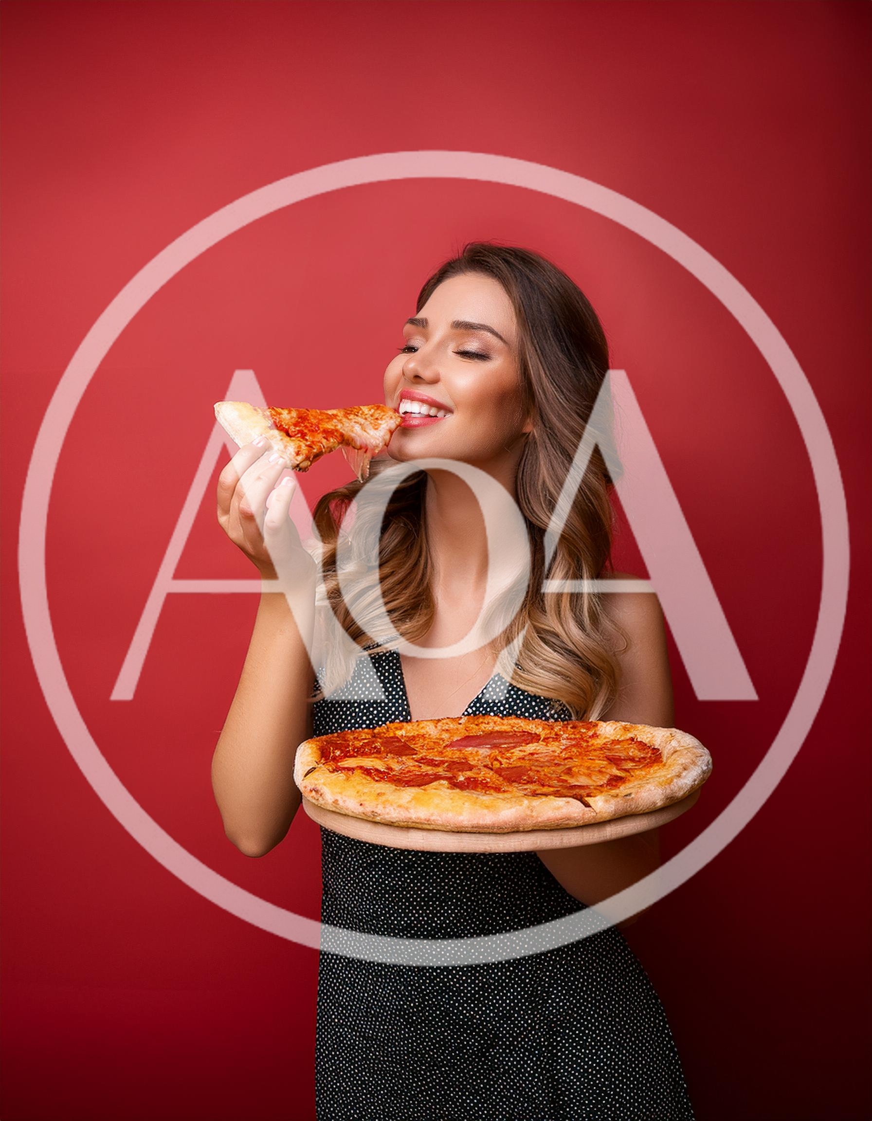Beautiful Woman Eating A Slice Of Pizza