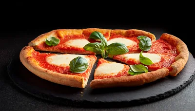 Fresh Margherita Pizza With Basil On Slate Board