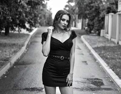 Young Woman Standing In The Rain On A Street