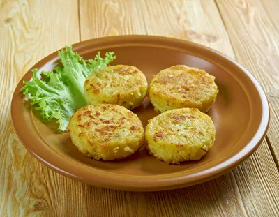 Four Golden Brown Potato Pancakes on a Plate