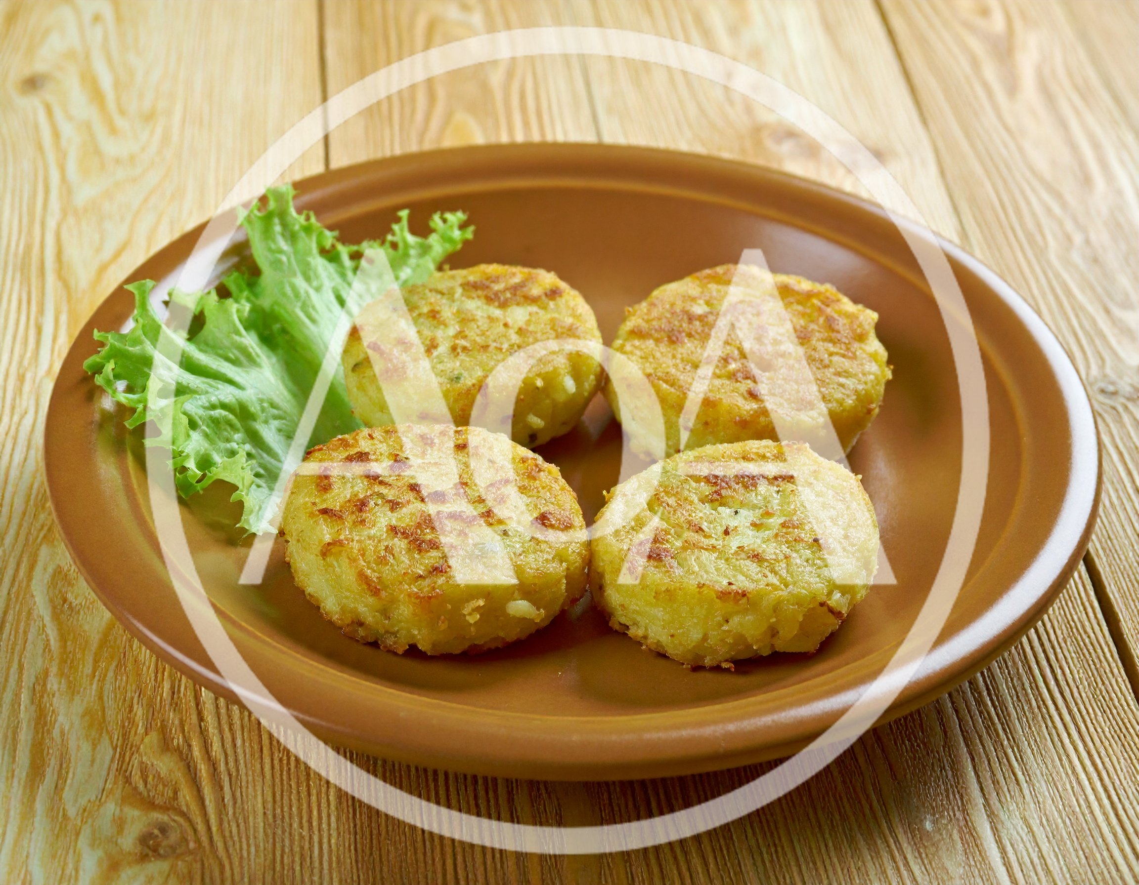 Four Golden Brown Potato Pancakes on a Plate