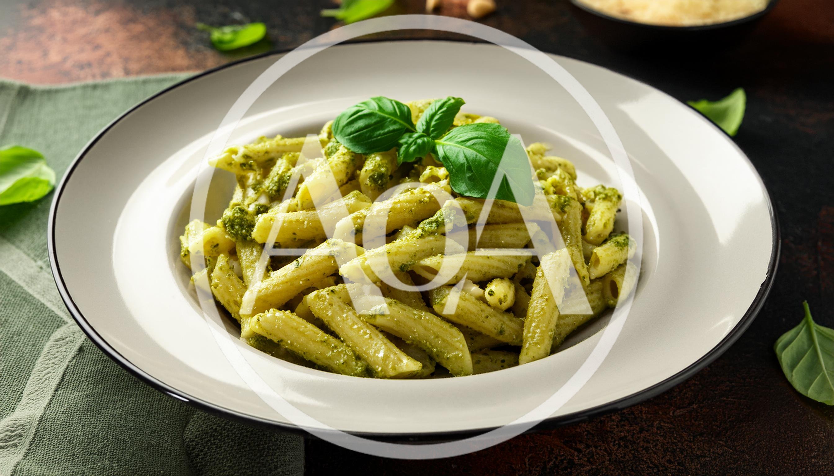 Penne Pasta With Pesto Sauce In A White Bowl